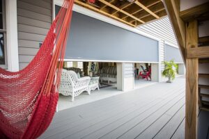 carroll architectural shade retractable shade screen halfway down over a garage entrance